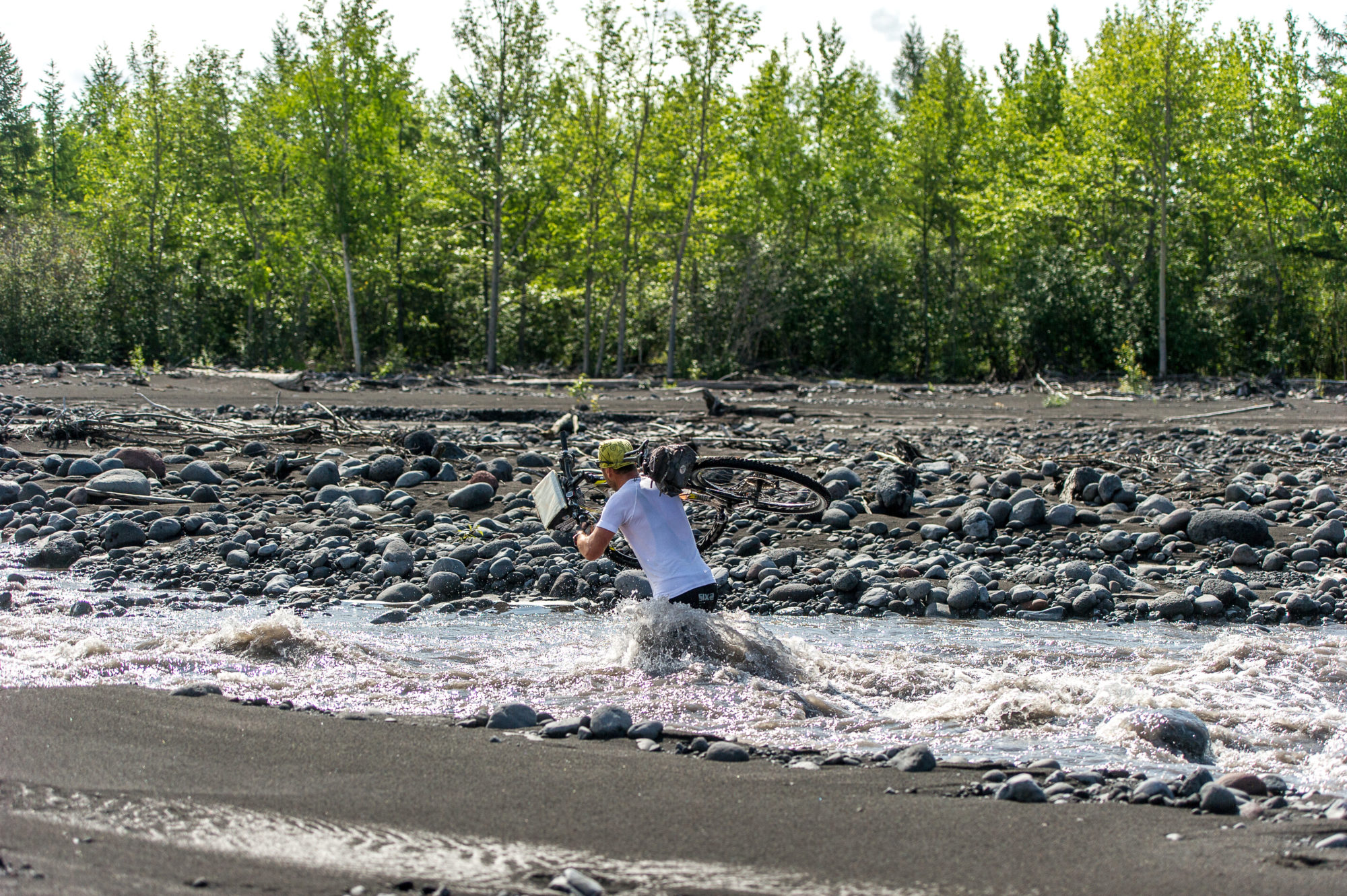 Foto di aldo mazzocchi guada un torrente con la bici sulle spalle